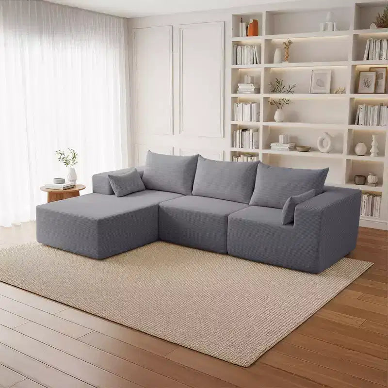Divano componibile a L in velluto a coste con pouf